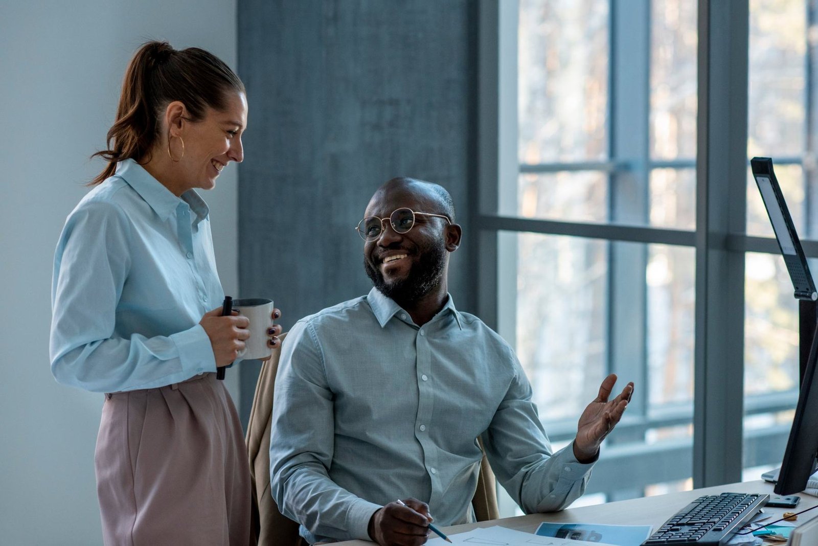 Two colleagues talking in an office