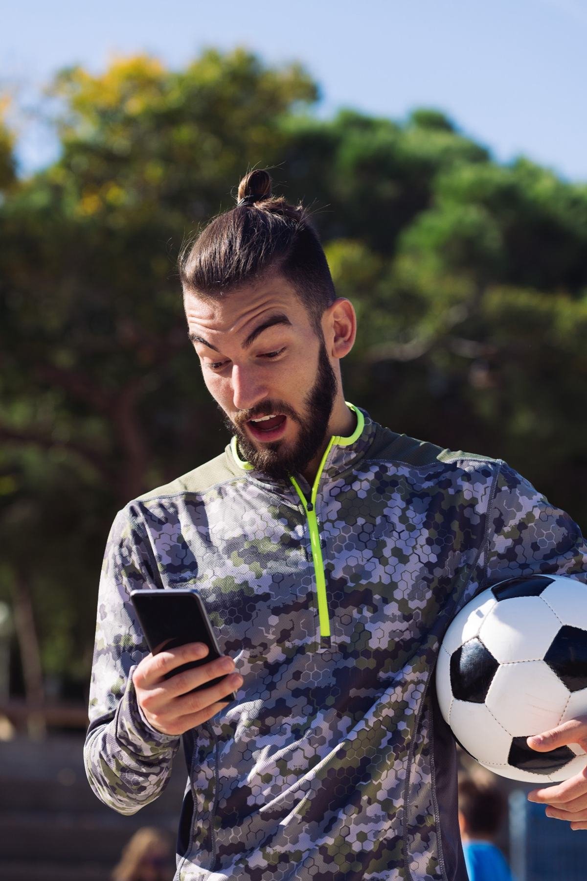 Sports fan using a phone